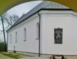 Moszczenica - the old parish church of Our Lady of Mount Caramel (Scapular) with the relief of archbishop Leon Wałęga on the outdoor wall of the presbytery