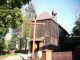Drewniany kościół w Marcinkach gm.Kobyla Góra -widok z prawej strony z za ogrodzenia